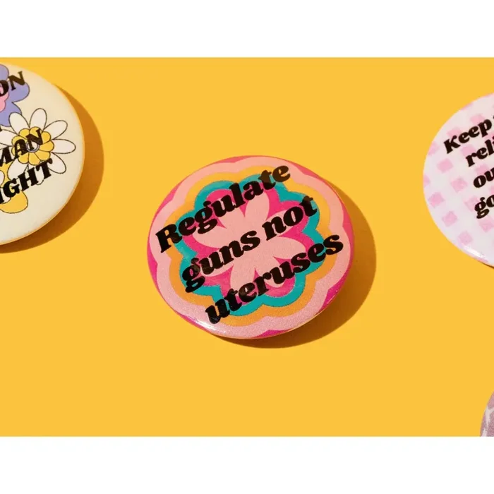 Regulate Guns Not Uteruses 1.25″ Button in Groovy Flower Motif